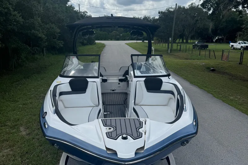 The Image of 2018 Yamaha Boats 242 Limited S E-Series on a rural road, showcasing sleek design and seating. - 4