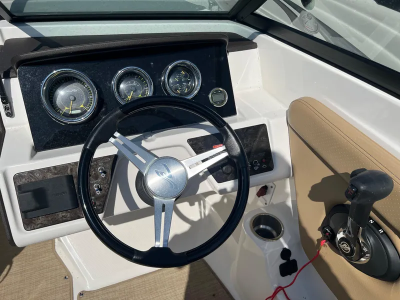 Slide: The Image of 2020 Sea Ray SPX 230 dashboard with steering wheel and control panel. - 10