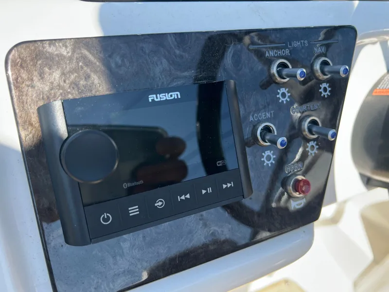 Slide: The Image of Control panel of a 2020 Sea Ray SPX 230 boat with Fusion audio system. - 11