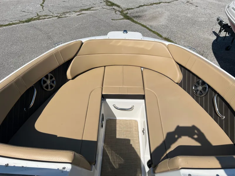 Slide: The Image of 2020 Sea Ray SPX 230 boat interior with tan seating and stainless steel accents. - 12