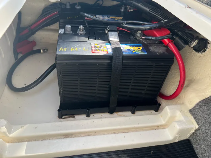 Slide: The Image of Battery compartment of a 2020 Sea Ray SPX 230 boat with secured wiring. - 17