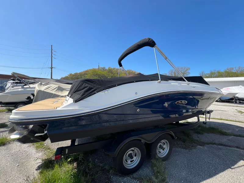 Slide: The Image of 2020 Sea Ray SPX 230 boat on trailer, blue and white, with black canopy. - 3
