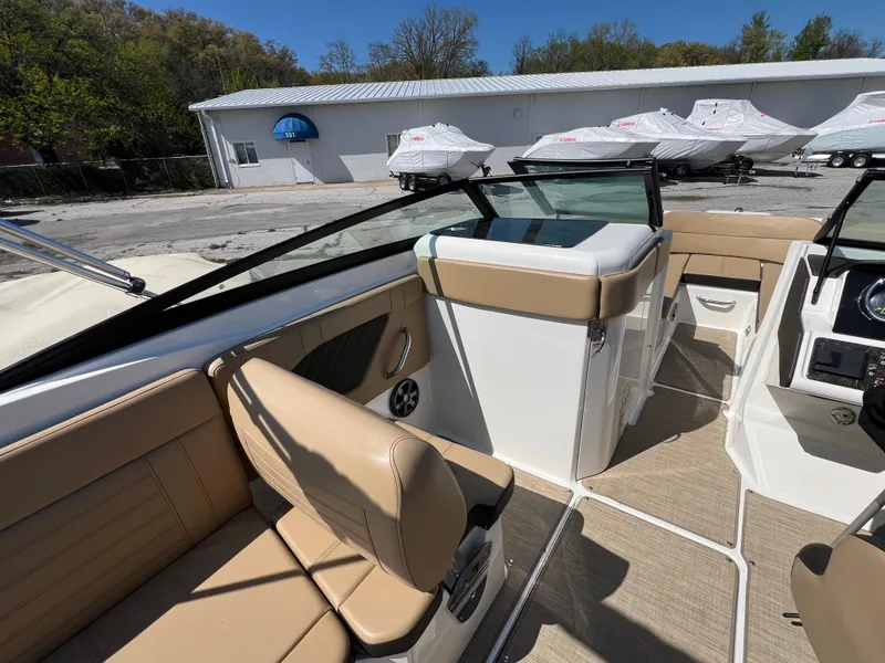Slide: The Image of 2020 Sea Ray SPX 230 boat interior with tan seating and modern design. - 7