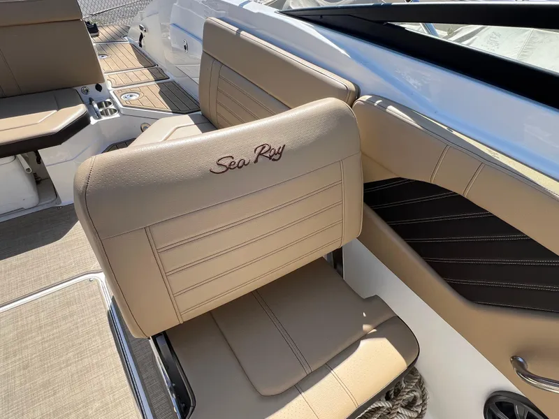 Slide: The Image of 2020 Sea Ray SPX 230 boat interior with beige seating and elegant design. - 8