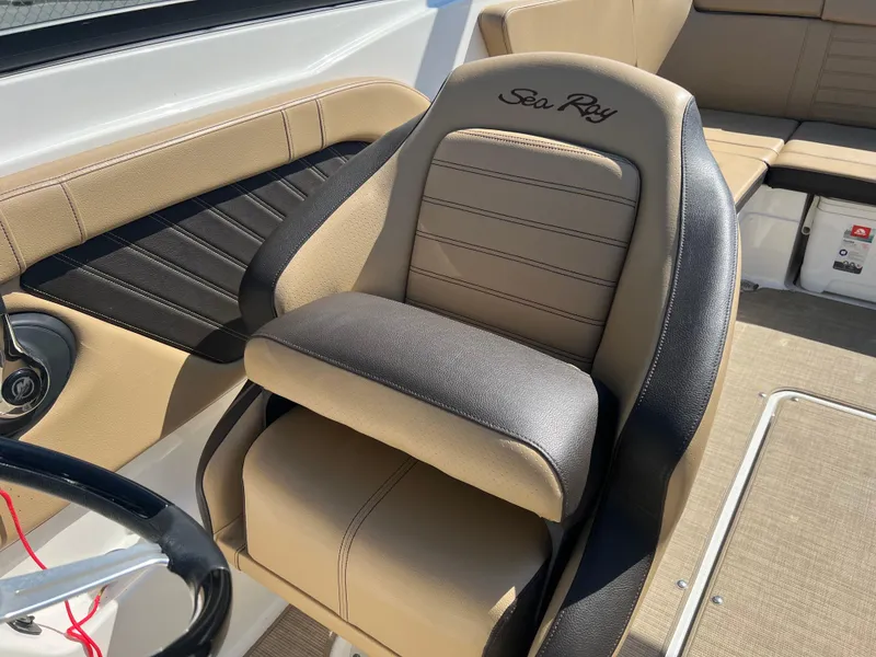 Slide: The Image of 2020 Sea Ray SPX 230 boat interior with tan and black seating. - 9