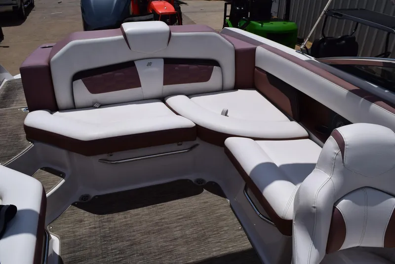 Slide: The Image of 2018 Four Winns HD240 OB boat interior with white and brown seating. - 11