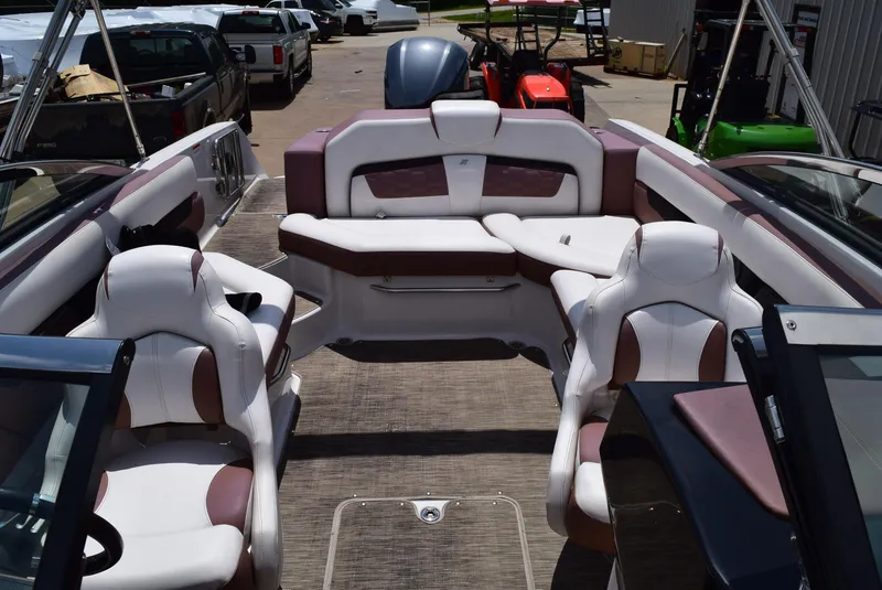 Slide: The Image of 2018 Four Winns HD240 OB boat interior with white and brown seating. - 12