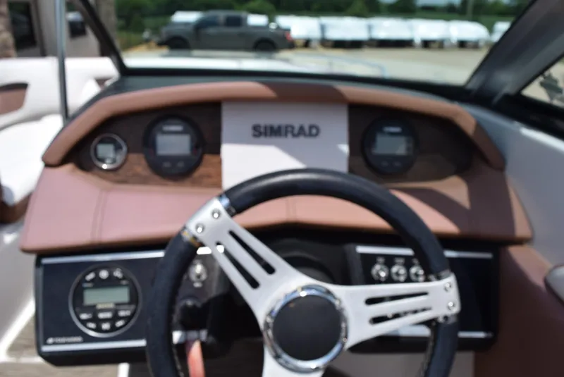 Slide: The Image of 2018 Four Winns HD240 OB boat dashboard with Simrad display and steering wheel. - 14