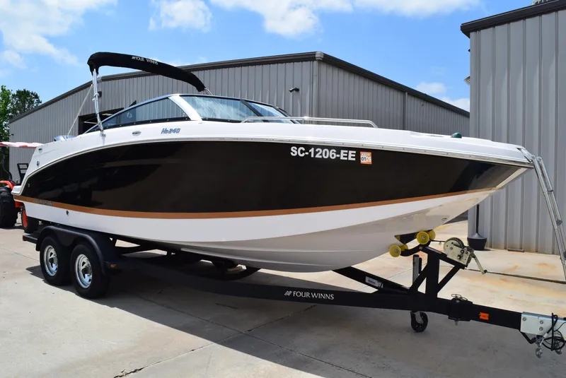 Slide: The Image of 2018 Four Winns HD240 OB boat on trailer, parked outdoors. - 3