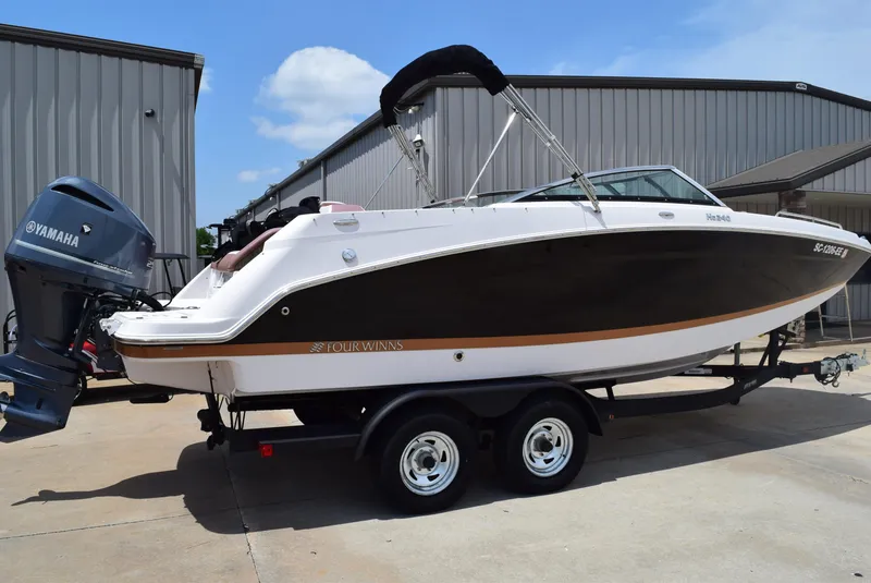 Slide: The Image of 2018 Four Winns HD240 OB boat on trailer, Yamaha outboard motor, parked near metal building. - 4