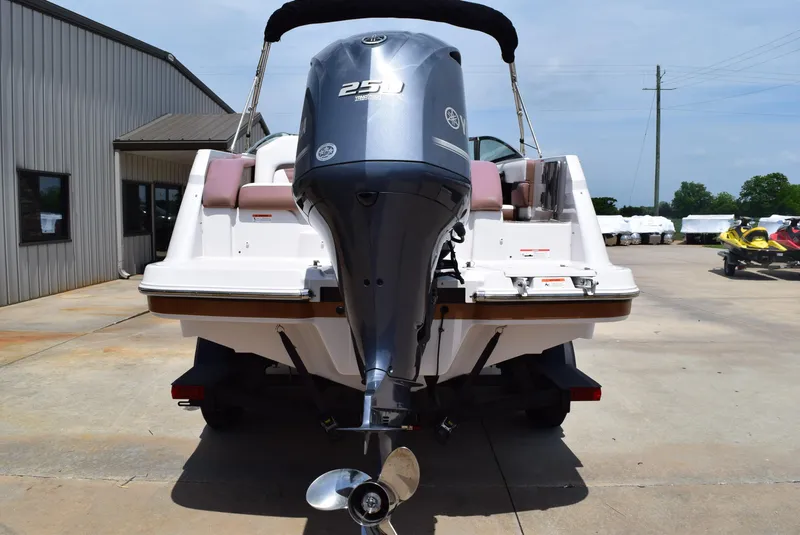 Slide: The Image of 2018 Four Winns HD240 OB boat with powerful outboard motor, parked outdoors. - 7