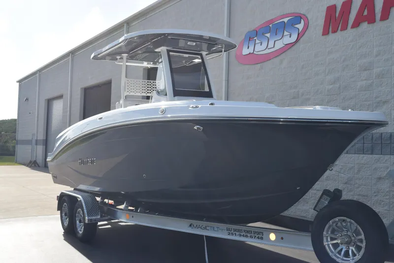 Slide: The Image of 2025 Hurricane Center Console 24 OB boat on trailer outside dealership. - 2
