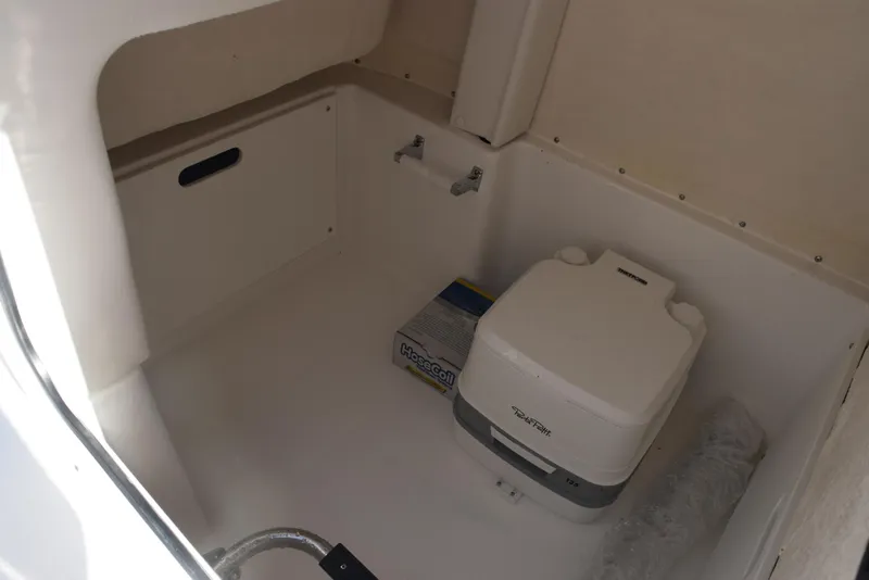 Slide: The Image of 2025 Hurricane Center Console 24 OB boat interior with portable toilet and storage space. - 21