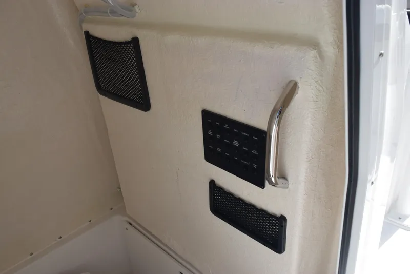 Slide: The Image of Interior of 2025 Hurricane Center Console 24 OB with control panel and storage nets. - 22