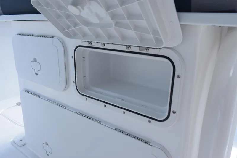 Slide: The Image of 2025 Hurricane Center Console 24 OB storage compartments, open and closed, showcasing interior space. - 25