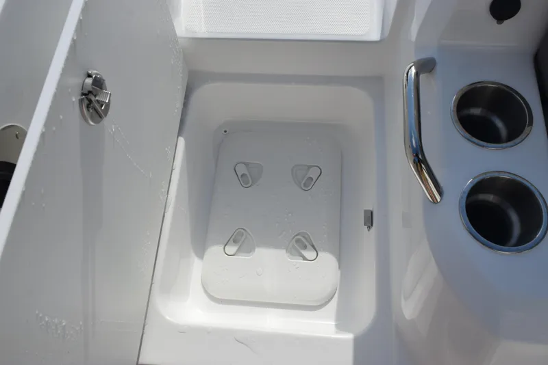 Slide: The Image of 2025 Hurricane Center Console 24 OB boat interior with storage hatch and cup holders. - 27