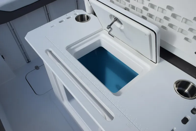Slide: The Image of 2025 Hurricane Center Console 24 OB boat with open storage compartment and cup holders. - 28