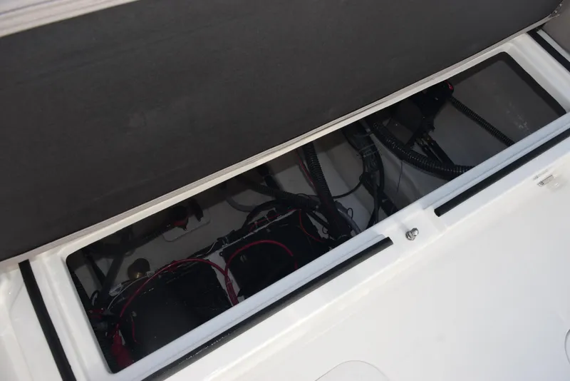 Slide: The Image of 2025 Hurricane Center Console 24 OB boat storage compartment with wiring and cables. - 29