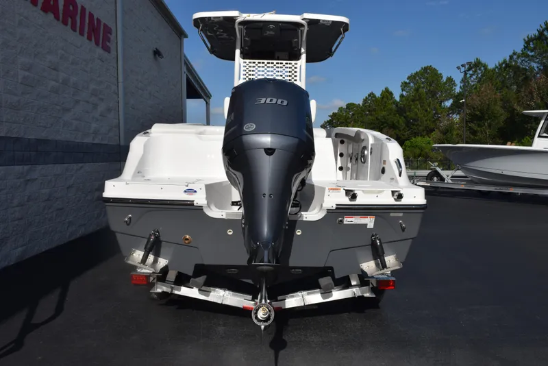 Slide: The Image of 2025 Hurricane Center Console 24 OB boat with powerful outboard motor, parked outdoors. - 5