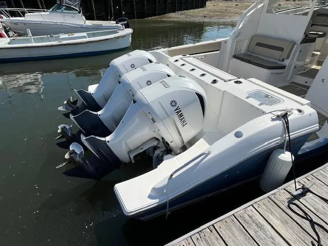 Slide: The Image of 2019 Pursuit DC 365 Dual Console boat with Yamaha outboard engines docked in marina. - 11
