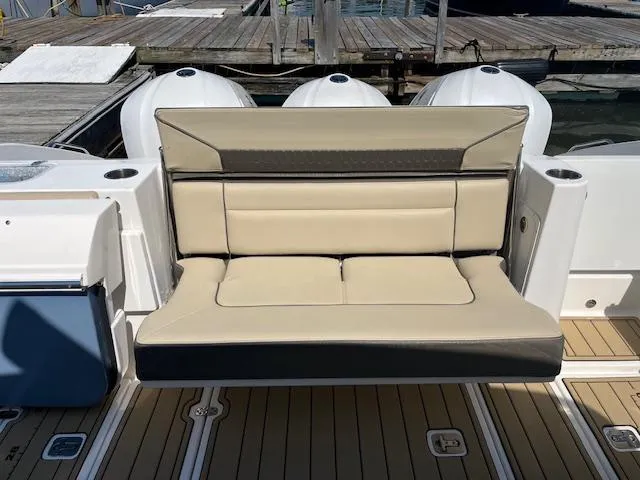 Slide: The Image of 2019 Pursuit DC 365 Dual Console boat with beige seating and triple outboard motors. - 17
