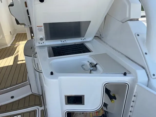 Slide: The Image of 2019 Pursuit DC 365 Dual Console boat with onboard kitchenette and grill. - 20
