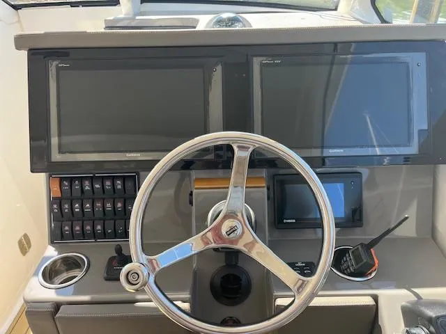 Slide: The Image of 2019 Pursuit DC 365 Dual Console dashboard with steering wheel and electronic displays. - 25