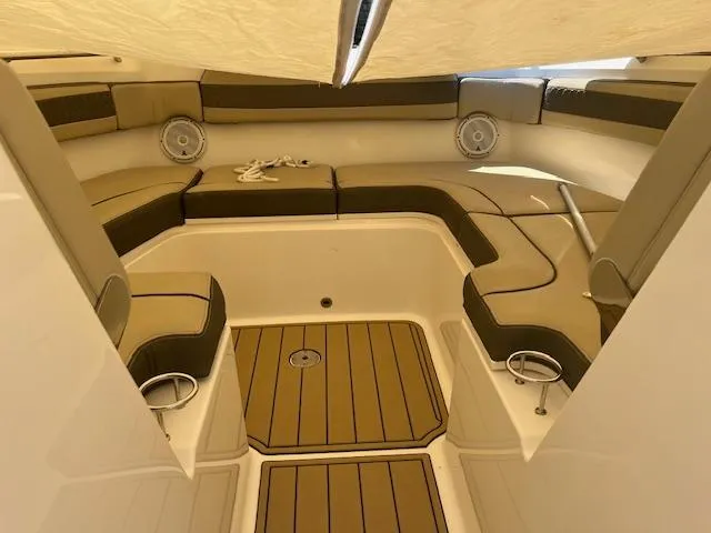 Slide: The Image of 2019 Pursuit DC 365 Dual Console boat interior with cushioned seating and teak flooring. - 34