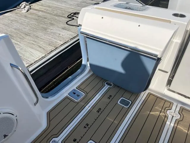 Slide: The Image of 2019 Pursuit DC 365 Dual Console boat deck with storage and teak flooring. - 39