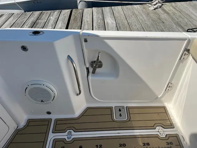 Slide: The Image of 2019 Pursuit DC 365 Dual Console boat deck with speaker and storage compartment. - 41