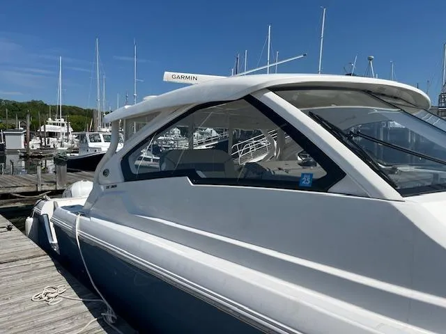 Slide: The Image of 2019 Pursuit DC 365 Dual Console boat docked at marina under clear blue sky. - 49