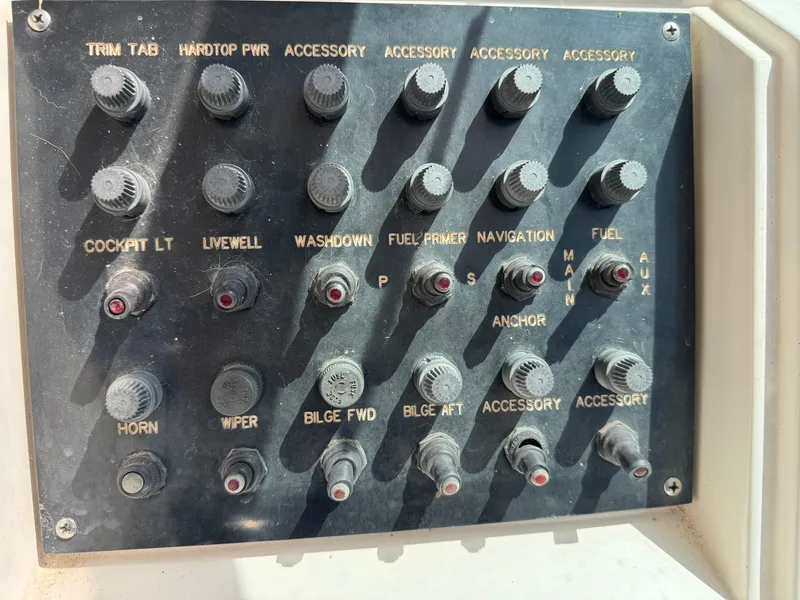Slide: The Image of Control panel of a 1990 Grady-White Marlin 28 boat with various switches. - 10