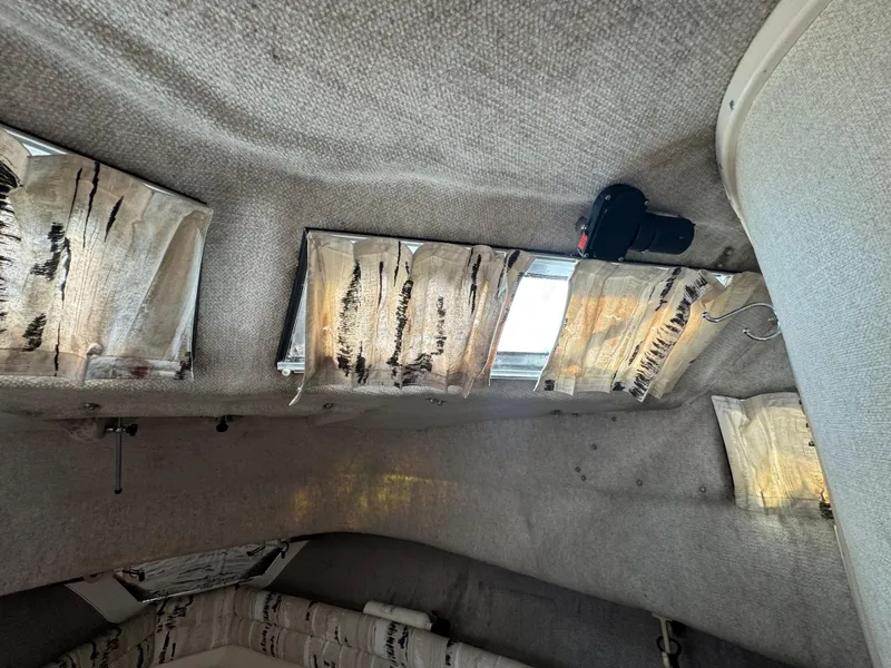 Slide: The Image of Interior cabin of 1990 Grady-White Marlin 28 boat with worn curtains and camera. - 17