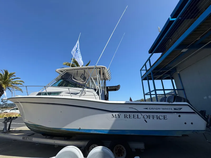 Slide: The Image of 1990 Grady-White Marlin 28 boat named "My Reel Office" on trailer, dockside view. - 2