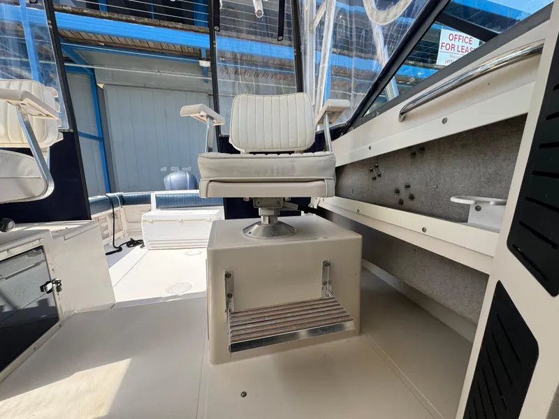 Slide: The Image of 1990 Grady-White Marlin 28 boat interior with captain's chair and footrest. - 21