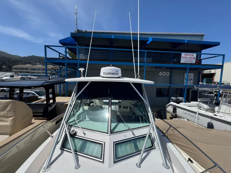 Slide: The Image of 1990 Grady-White Marlin 28 boat with Garmin equipment, docked near a marina office. - 29