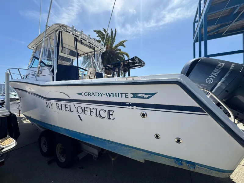 Slide: The Image of 1990 Grady-White Marlin 28 boat on trailer, named "My Reel Office," with Yamaha engines. - 3