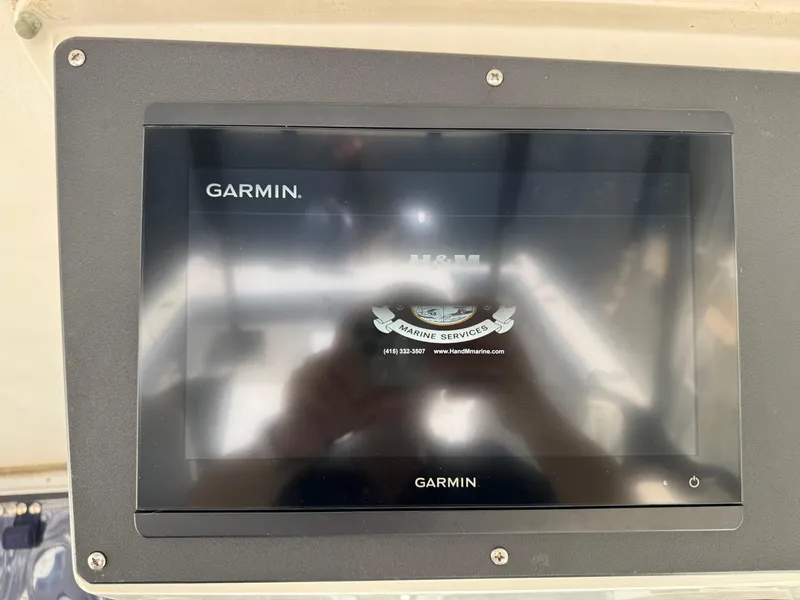Slide: The Image of Garmin marine display on a 1990 Grady-White Marlin 28 boat dashboard. - 30