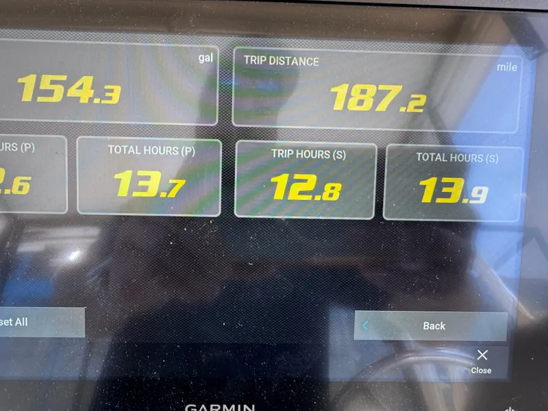 Slide: The Image of Dashboard display showing trip data: 154.3 gallons, 187.2 miles, 1990 Grady-White Marlin 28. - 33