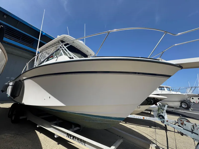 Slide: The Image of 1990 Grady-White Marlin 28 boat on trailer, viewed from the front, under clear blue sky. - 7