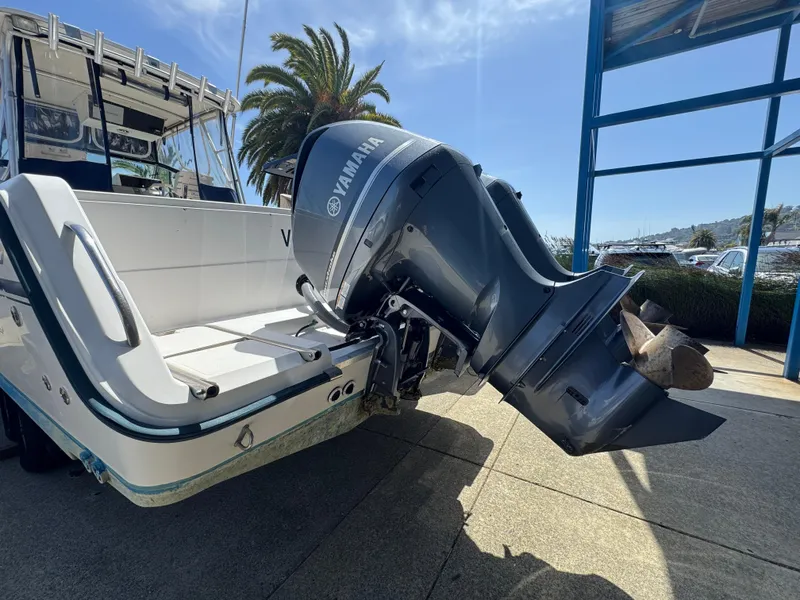 Slide: The Image of 1990 Grady-White Marlin 28 boat with Yamaha outboard motor, docked under clear sky. - 8