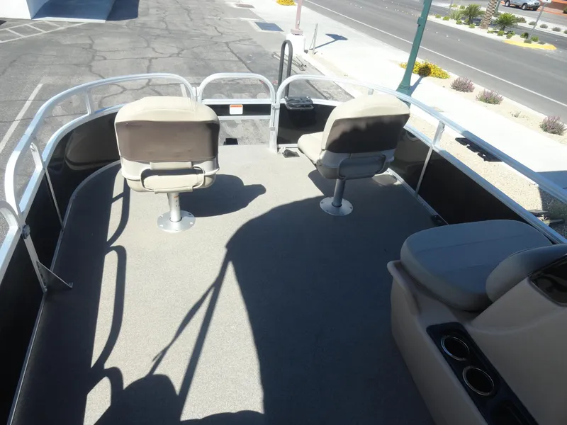 Slide: The Image of 2019 Sun Tracker Bass Buggy 18 DLX pontoon boat interior with seating and railing. - 12