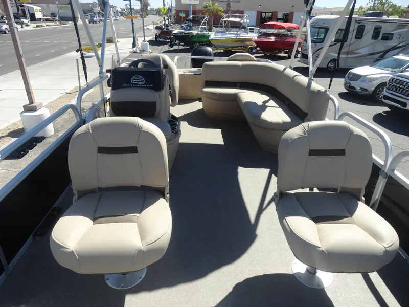 Slide: The Image of 2019 Sun Tracker Bass Buggy 18 DLX pontoon boat with beige seating and spacious deck. - 13