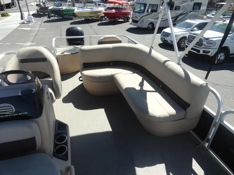 Slide: The Image of 2019 Sun Tracker Bass Buggy 18 DLX pontoon boat with beige seating and cup holders. - 16