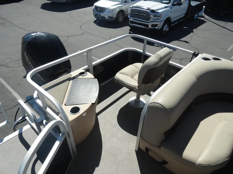 Slide: The Image of 2019 Sun Tracker Bass Buggy 18 DLX pontoon boat interior with seating and motor. - 17