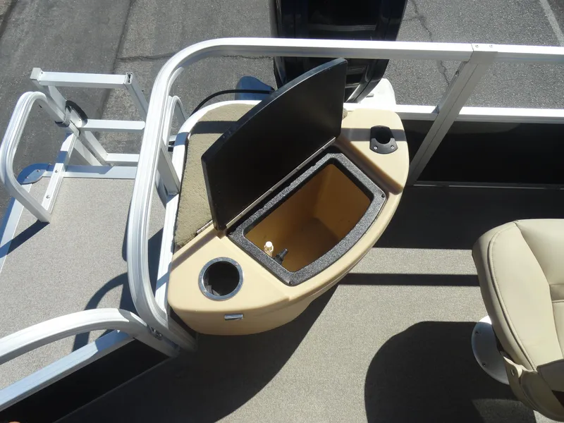 Slide: The Image of 2019 Sun Tracker Bass Buggy 18 DLX boat with open storage compartment and cup holder. - 18