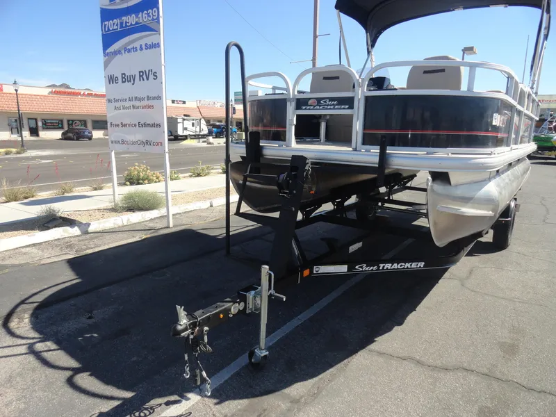 Slide: The Image of 2019 Sun Tracker Bass Buggy 18 DLX pontoon boat on trailer in parking lot. - 20