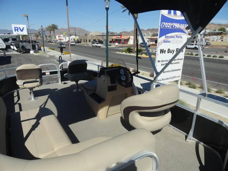 Slide: The Image of 2019 Sun Tracker Bass Buggy 18 DLX pontoon boat interior with seating and steering console. - 8