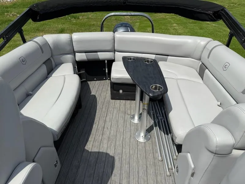 Slide: The Image of 2019 Godfrey Aqua Patio 235 UL pontoon boat interior with gray seating and table. - 10