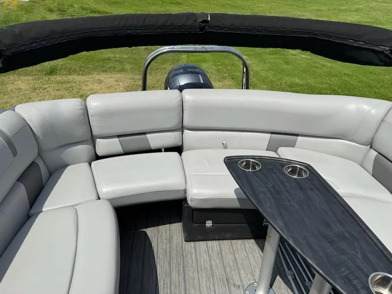 Slide: The Image of 2019 Godfrey Aqua Patio 235 UL boat interior with gray seating and table. - 11